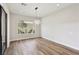 Bright dining room with hardwood floors and a modern chandelier at 4973 Sandline Ct, Las Vegas, NV 89135