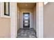 Inviting entryway with modern front door and tile flooring at 4973 Sandline Ct, Las Vegas, NV 89135