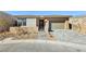 Single-story home with attached garage and landscaped front yard at 4973 Sandline Ct, Las Vegas, NV 89135