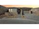 Single-story home with attached garage and landscaped front yard at 4973 Sandline Ct, Las Vegas, NV 89135