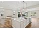 Gourmet kitchen with a large center island and stainless steel appliances overlooks the living area at 4973 Sandline Ct, Las Vegas, NV 89135