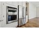 Stainless steel refrigerator, microwave, and oven complement the modern kitchen design at 4973 Sandline Ct, Las Vegas, NV 89135