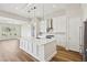 Modern kitchen with white cabinets, large island, and stainless steel appliances at 4973 Sandline Ct, Las Vegas, NV 89135