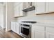 White kitchen with stainless steel appliances and gas cooktop at 4973 Sandline Ct, Las Vegas, NV 89135