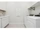 Laundry room with washer, dryer, and shelving at 4973 Sandline Ct, Las Vegas, NV 89135