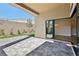 Covered patio with sliding glass doors opening to the living room and backyard at 4973 Sandline Ct, Las Vegas, NV 89135