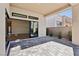 Covered patio with sliding glass doors opening to the living room at 4973 Sandline Ct, Las Vegas, NV 89135