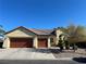 Tan two-story house with brown roof and two-car garage at 5016 Wayfaring Tree Ave, Las Vegas, NV 89131