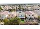 Aerial view of backyard with patio cover, artificial turf and lush landscaping at 5028 Frozen Springs Ct, Las Vegas, NV 89130