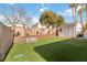 Well-maintained backyard featuring artificial grass, a shed, and a decorative retaining wall at 5028 Frozen Springs Ct, Las Vegas, NV 89130