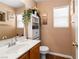 Bathroom featuring a vanity, toilet, and decor with natural lighting from a window at 5028 Frozen Springs Ct, Las Vegas, NV 89130