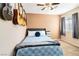 Cozy bedroom with a ceiling fan, soft carpet, and guitars for decoration at 5028 Frozen Springs Ct, Las Vegas, NV 89130