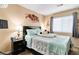 Bedroom featuring a queen bed, nightstand, and a window for natural lighting at 5028 Frozen Springs Ct, Las Vegas, NV 89130