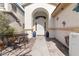 Inviting front entrance with an arched entryway and a shaded seating area at 5028 Frozen Springs Ct, Las Vegas, NV 89130