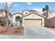 Charming two-story home with a well-maintained lawn and a two-car garage at 5028 Frozen Springs Ct, Las Vegas, NV 89130