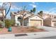 Inviting two-story home with a two-car garage, desert landscape and lush foliage at 5028 Frozen Springs Ct, Las Vegas, NV 89130