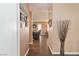 Bright hallway with hardwood floors, neutral walls, and decorative touches providing a seamless transition between rooms at 5028 Frozen Springs Ct, Las Vegas, NV 89130