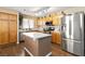 Modern kitchen with stainless steel appliances, ample counter space, and wood cabinets creating a functional cooking area at 5028 Frozen Springs Ct, Las Vegas, NV 89130