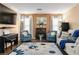 Cozy living room featuring comfortable seating, a fireplace, and a stylish rug, perfect for relaxation at 5028 Frozen Springs Ct, Las Vegas, NV 89130