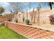 Close up of a brick retaining wall with landscaping and artificial turf at 5028 Frozen Springs Ct, Las Vegas, NV 89130