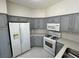 Bright kitchen featuring stainless steel appliances, gray cabinets and white countertops at 5225 W Reno Ave # 129, Las Vegas, NV 89118