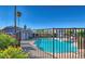 Inviting community pool area with surrounding fence and landscaping at 5350 Rod Ct # 202, Las Vegas, NV 89122