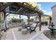 Relaxing backyard patio with pergola, seating area, and hot tub at 5992 Genovese Ave, Las Vegas, NV 89141