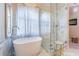 Spa-like bathroom with a freestanding soaking tub and walk-in shower at 5992 Genovese Ave, Las Vegas, NV 89141