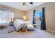 Bright bedroom with a queen-size bed, ample natural light, and window coverings at 5992 Genovese Ave, Las Vegas, NV 89141