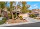 Two story house with attached garage and landscaped yard at 5992 Genovese Ave, Las Vegas, NV 89141