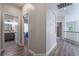 Bright hallway with light wood flooring and neutral wall tones at 5992 Genovese Ave, Las Vegas, NV 89141