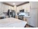 Modern kitchen with stainless steel appliances and white cabinets at 5992 Genovese Ave, Las Vegas, NV 89141