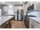 Modern kitchen with stainless steel appliances and white cabinets at 5992 Genovese Ave, Las Vegas, NV 89141