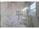 Stunning walk-in shower with marble tile and glass enclosure at 5992 Genovese Ave, Las Vegas, NV 89141