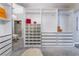 Large walk-in closet with custom shelving and mirrored doors at 5992 Genovese Ave, Las Vegas, NV 89141