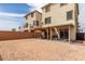 Backyard with gravel features a covered patio area and block wall perimeter at 6075 Wyndham Estate Ave, Las Vegas, NV 89141