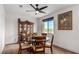 Formal dining room with a dark wood table and matching hutch and a scenic outside view at 6075 Wyndham Estate Ave, Las Vegas, NV 89141