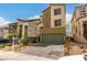 Modern home featuring a green garage door, neutral paint, and desert landscaping at 6075 Wyndham Estate Ave, Las Vegas, NV 89141