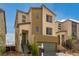 Two-story home with green garage door and light brown and beige exterior at 6075 Wyndham Estate Ave, Las Vegas, NV 89141