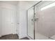 Modern tiled walk-in shower features a glass door, tiled walls and a built-in shelf at 6075 Wyndham Estate Ave, Las Vegas, NV 89141