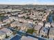 Aerial shot showcases community with beige homes, desert landscaping, and views of the city at 6178 Pisan Ln, Las Vegas, NV 89148