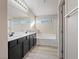 Well-lit bathroom featuring a double vanity, separate tub, shower and window, perfect for a relaxing experience at 6178 Pisan Ln, Las Vegas, NV 89148