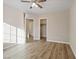 Cozy bedroom with a ceiling fan, wood-look floors, and natural light from the window creates a relaxing atmosphere at 6178 Pisan Ln, Las Vegas, NV 89148