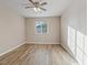 Well-lit bedroom features wood-look flooring and ample natural light from the window, creating a bright and airy atmosphere at 6178 Pisan Ln, Las Vegas, NV 89148