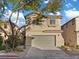 Charming two-story home with a two-car garage, desert landscaping, and neutral-toned stucco in a residential neighborhood at 6178 Pisan Ln, Las Vegas, NV 89148