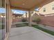 Covered back patio with a concrete floor and minimal landscaping at 6178 Pisan Ln, Las Vegas, NV 89148