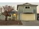 Two-story house featuring solar panels and a beige garage door at 6240 Viewpoint Dr, Las Vegas, NV 89156