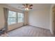 Cozy bedroom with ceiling fan and natural light from large windows at 6403 Ava Ridge Ave, Las Vegas, NV 89141