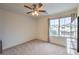 Bright bedroom with large window, ceiling fan, and city view at 6403 Ava Ridge Ave, Las Vegas, NV 89141