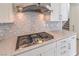 Modern gas cooktop with contemporary backsplash and white cabinets at 6403 Ava Ridge Ave, Las Vegas, NV 89141